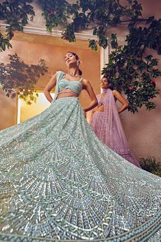 Featuring a mint green tulle lehenga embroidered fully by hand with various ornamental lustre sequences and Japanese bugle beads. It is paired with a scallop dupatta with crystal drops and blouse.From Aneesh Agarwaal's Ellora collection.DELIVERY TIMEPlease allow 8-12 weeks for your outfit to arrive.FABRIC DETAILSNetProfessional cleaning only. Glamorous Green Choli For Wedding, Glamorous Green Choli For Festive Season, Wedding Green Hand Embellished Choli, Glamorous Green Choli For Festive Occasions, Embellished Green Gown For Festivals, Glamorous Festive Green Choli, Green Hand Embellished Lehenga For Reception, Festive Green Glamorous Choli, Glamorous Green Lehenga For Wedding