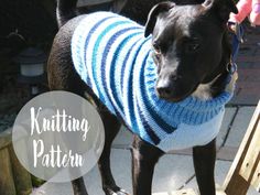 a black dog wearing a blue and white striped sweater with the words knitting patteria on it