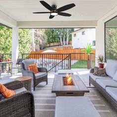 an outdoor living area with wicker furniture and a fire pit