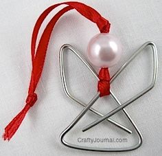 an ornament with a white pearl and red string on it's side