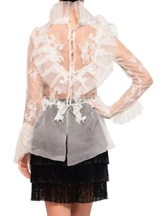 The collectible evening blouse is a specialty of Ukraine's Maison Sophy G, whose designer Sophy Geyder named the label after her beloved childhood doll. This confection of chiffon and lace features intricate ruffles in sheer chiffon topping the bodice for coverage. The look is finished with lace appliques, ruffled cuffs and a peplum. It is the perfect blouse to wear over a pair of simple black trousers or slim skirt for a very special night out. In white. Made in Ukraine.COMPOSITION & CARE100% s Evening Blouses, Slim Skirt, Perfect Blouse, Peplum Blouse, Black Trousers, Sheer Chiffon, Lace Applique, Chiffon Tops, Appliques