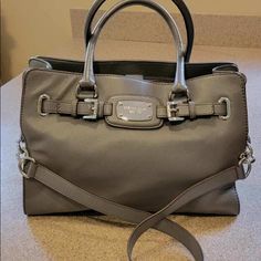 *Rare Find* Michael Kors Tote/Shoulder Bag 100% Authentic: Like New-Nwot Color: Grey Material: Soft Pebbles Leather Silver Tone Hardware Strap: Double Handle / Longer Chain Strap 2 Main Compartment Plus Zip Full Length Pocket Interior Zip Pocket/2 Open Pockets Fabric Lining Very Light Scratches On Face Plate And Feet Measurements: 14” L X 13” H X 5” D As As-No Returns Designer Travel Satchel With Silver-tone Hardware, Classic Satchel With Silver-tone Hardware For Errands, Classic Michael Kors Satchel With Handles, Luxury Michael Kors Satchel For Travel, Michael Kors Satchel With Silver-tone Hardware For Shopping, Michael Kors Satchel With Silver-tone Hardware, Classic Michael Kors Bags With Silver-tone Hardware, Designer Michael Kors Satchel With Branded Hardware, Designer Michael Kors Travel Satchel