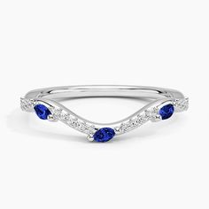 a white gold ring with blue sapphire and diamonds