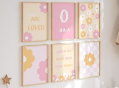 four pink and yellow wall art hanging on a white wall in a child's room