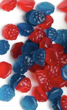 red, white and blue gummy bears on a white surface