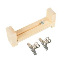 two wooden pegs are attached to the handle of a pair of metal hooks on a white background