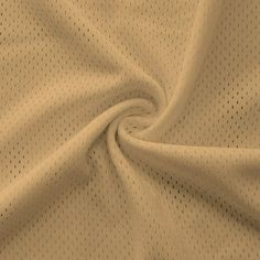 a close up view of a white fabric with small dots on it, as well as the