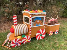 a toy train with candy canes and a teddy bear in the driver's seat