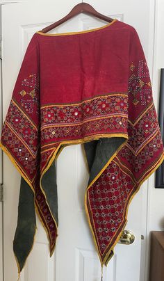 This is a beautifully embroidered vintage shawl poncho in the traditional India Banjara style. Some wear around the neck hole, as pictured, otherwise in great condition. Measures 52" x 80". Bohemian Shawl With Embroidered Border For Festival, Traditional Shawl With Embroidered Border, Bohemian Kaftan With Dupatta For Traditional Ceremonies, Traditional Dupatta With Border In Shawl Shape, Embroidered Shawl With Border For Festivals, Bohemian Pashmina Shawl With Resham Embroidery, Embroidered Border Shawl For Festivals And Traditional Ceremonies, Vintage Festive Dupatta With Traditional Patterns, Vintage Dupatta For Festivals With Traditional Drape