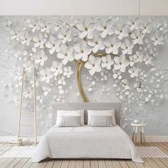 the bedroom is decorated with white flowers on the wall, and there are two tables in front of the bed