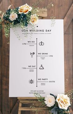 a wedding program with flowers and greenery on the side of a wooden table next to a sign