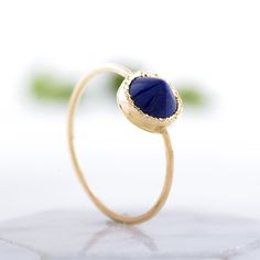 Striking lapis lazuli ring with a spike, unique gold ring, statement ring. The ring is 100% handcrafted in 14k gold. The stone is in bezel hammered setting In the back of the ring there is tiny heart cut out. This ring can be a wonderful Birthday or holiday gift for a Woman. CENTRAL STONE: *natural lapis lazuli *shape: round peaked stone *color: purple/blue *stone with setting: 7.4mm SPECIFICATIONS: *band: 1 mm, high polish *material: 14k yellow gold (this ring is also available in 14k rose or w Round Lapis Lazuli Cabochon Rings, Lapis Lazuli Cabochon Rings, Yellow Gold Lapis Lazuli Gemstone Rings, Yellow Gold Rings With Lapis Lazuli Gemstone, Gold Lapis Lazuli Gemstone Rings, Gold Rings With Lapis Lazuli Gemstone, Lapis Lazuli Gemstone Rings Fine Jewelry, Fine Jewelry Lapis Lazuli Rings For Gifts, Fine Jewelry Lapis Lazuli Gemstone Rings