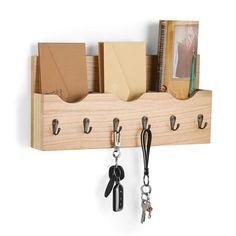 a wooden shelf with several keys hanging from it's hooks and two pairs of lanyards