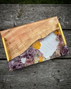 an empty wooden box with flowers on it