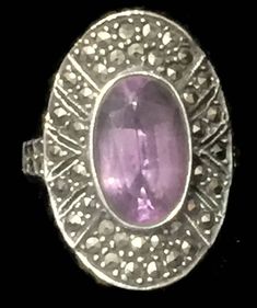 "Vintage Long Marcasite & Amethyst Ring w Art Deco Style Size 6.75 Weight 6.7g Length 1\" Width 5/8\" Rings are Delivered in a Gift Box Free Domestic USA Shipping & Free Postal Insurance If you do not want the ring polished and want to leave the natural patina please let me know at the time of purchase as I do polish rings before I ship rings out. Thanks USPS Domestic Shipping is free for buyers. If a buyer prefers to upgrade to priority, the buyer will pay that portion of the shipping c Hallmarked Oval Purple Ring, Oval Purple Hallmarked Ring, Collectible Amethyst Art Deco Rings, Collectible Art Deco Amethyst Rings, Collectible Oval Amethyst Ring In Art Deco Style, Art Deco Amethyst Oval Ring, Collectible Art Deco Purple Rings, Antique Oval Amethyst Multi-stone Ring, Art Deco Amethyst Ring With 17 Jewels