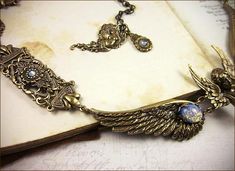 Valkyrie Necklace - Sky Blue Opal Art Glass - Antiqued Brass - Rabbitwood & Reason Elegant Winged Metal Jewelry, Assemblage Jewelry, Goddess Of Love, Aphrodite, Collar Necklace, Necklace Length, Antique Brass, Lobster Clasp, Jewelry Pieces