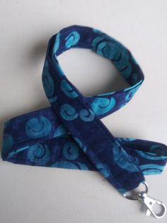 "Blue and dark blue lanyard. This listing is for ONE lanyard! Handmade by me with 100% cotton fabric measuring approximately 40-42 inches around(20\"-21\" Drop when placed around neck) and 3/4 inch wide. A key ring and a swivel clasp/hook are attached to the lanyard. Lanyards can be used for functional purposes such as I.D. wearing and attaching to keys for easy around-the-neck-wearing. This one would make an awesome gift. Hand washing recommended for lanyard, lay flat to dry. Thank You for shop Blue Lanyard With Key Leash For Gift, Blue Lanyard With Key Leash As Gift, Blue Lanyards With Key Leash As Gift, Handmade Blue Lanyards For Gifts, Handmade Blue Lanyards As Gifts, Handmade Blue Lanyard As Gift, Lanyard Blue, Keychain Lanyard, Badge Lanyard