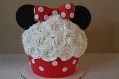 a minnie mouse cupcake decorated with white frosting