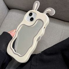 a person holding a cell phone case in their hand