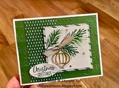 someone holding up a christmas card made with stampin's pine cone dieing