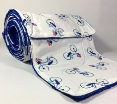 a blue and white bicyclist print cloth rolled up on top of each other