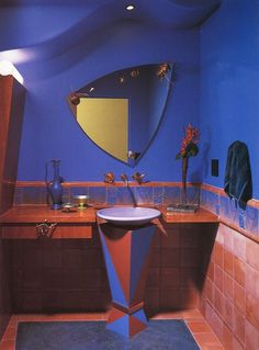 a bathroom with blue walls and red tile