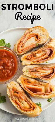 a white plate topped with sandwiches covered in meat and tomato sauce next to a bowl of salsa