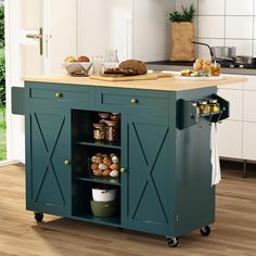 a kitchen island with food on it in the middle of a room