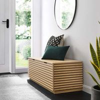 a black bench sitting in front of a white door next to a potted plant