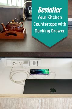 a kitchen counter with an apple computer on it and the words declutter your kitchen counters with docking drawer