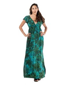 The Shoreline Long Dress is in a traditional rayon batik. It is a technique of wax-resist dyeing applied to the whole rayon cloth. This technique originated from the island of Java, Indonesia. It features a deep V neck design, cap shoulders and a tie right underneath the chest. It also has two side pockets and two small slits at the bottom hem which falls right at the ankle. This dress will elevate your look instantly. Green V-neck Batik Print Dress, Green Batik Print V-neck Dress, Green Hawaiian V-neck Dress, Green Batik Print Maxi Dress For Beach, Casual V-neck Batik Print Maxi Dress, Resist Dyeing, V Neck Design, Wax Resist, Batik Dress