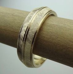 This bevel-edge  band is hand Florentine  all-round  approximately 6.5mm wide and weight is  approximately  10 to 11 grams of 14k yellow gold. The band is milgrain in the center and sides. Available in all finger sizes from 8 - 12.  Sizing outside of that range is a special order, contact for pricing and info.Each band is made to order and is a final sale.  If you need the band sooner than the listed processing time, we may able to do a rush order if our workload permits.We love this ring becaus Luxury 14k Gold Jewelry With Decorative Band, Engraved Yellow Gold Bands For Formal Occasions, Anniversary Bands In Polished Yellow Gold, Gold Timeless Bands For Anniversary, Timeless Wide Band Wedding Bands, Heirloom 14k Gold Wedding Band Thick Shape, Anniversary Yellow Gold Bands With Polished Finish, Heirloom Engraved Ring Stamped 14k For Marriage, Anniversary Yellow Gold Polished Bands