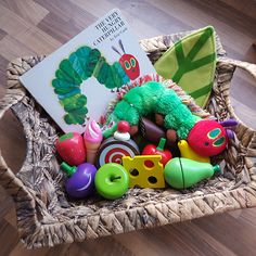 the very hungry caterpillar basket is filled with toys and books for children to read