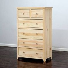 a wooden dresser sitting on top of a hard wood floor