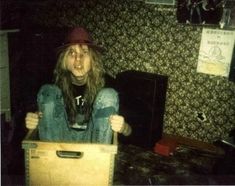 a woman with long hair sitting in a box