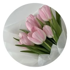 a bouquet of pink tulips sitting on top of a white plate