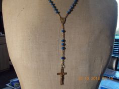 "Vintage French  Rosary Beads Necklace in Blue crucifix Cross religious chain Jesus cross jewellery Vintage French  Vintage French Rosary Beads Necklace crucifix Cross religious chain Jesus cross. Nice necklace Gold in colour with Blue beads, length of chain that goes around your neck is 21\" (53cm) but does have an extra drop of 5\" (13cm) where the cross hangs down. Nice piece of religious jewellery. Christian cross. Please have a look at my other Rosary bead chains for sale." Blue Crucifix Cross Necklace For A Gift, Blue Crucifix Necklace For Spiritual Wear, Blue Crucifix Necklace For Spiritual Purposes, Spiritual Blue Cross Pendant Necklace, Handmade Blue Crucifix Jewelry, Adjustable Blue Cross Necklace, Blue Adjustable Cross Necklace, Blue Cross Spiritual Necklace, Handmade Blue Rosary With Cross Shape