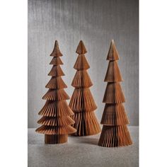 three wooden christmas trees sitting next to each other