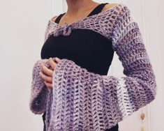 This shrug is a unique accessory to style in winter and spring. Chic Wrap Shrug For Fall, Chic Fall Wrap Shrug, One Size Wrap Shrug For Fall, Fitted Wrap Shrug For Fall, One Size Long Sleeve Winter Shrug, One Size Spring Wrap Shrug, Spring Long Sleeve Shrug One Size, Bohemian Fitted Shrug For Winter, Purple Crochet Projects