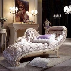 an ornate chaise lounge with white fur on the floor