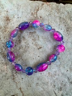 I handcrafted a galaxy bracelet. It is made with stretchy string and glass beads. Adjustable Glass Stretch Bracelet With Spacer Beads, Adjustable Iridescent Beaded Stretch Bracelet, Galaxy Bracelet, Earth Air Fire Water, Knoxville Tn, Lava Rock, Glass Bracelet, Bracelet Set, Arm Band