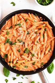 a skillet filled with pasta and parmesan cheese