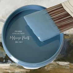 a blue paint can with a brush in it and the words paris collection on it