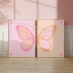 two pink and yellow butterfly prints on the wall in a room with hardwood floors,