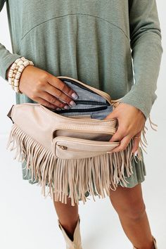 - This casual bag has boho flair! - Sleek lightweight material with long fringe detailing - Two zip closure front pockets - An adjustable shoulder strap - A spacious fully lined interior with a zip closure and additional inside zip closure pocket Spring Travel Bags With Fringe, Trendy Beige Shoulder Bag With Fringe, Beige Fringe Shoulder Bag For Travel, Beige Fringed Hobo Bag For Daily Use, Beige Fringe Hobo Bag For Daily Use, Spring Beige Shoulder Bag With Fringe, Beige Fringe Shoulder Bag For Spring, Spring Beige Fringe Shoulder Bag, Chic Travel Hobo Bag With Fringe