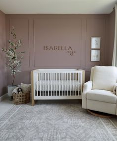 a baby's room with a crib, chair and rug