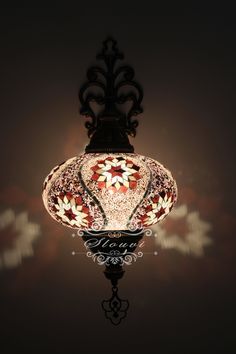 a lamp hanging from the ceiling in a dark room