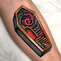 a tattoo on the leg of a man with an object in it's center