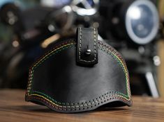 a black leather case sitting on top of a wooden table