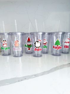 the cups are lined up on the counter to be filled with different types of stickers